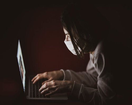 Close up of someone maintaining a healthy distance from a laptop screen